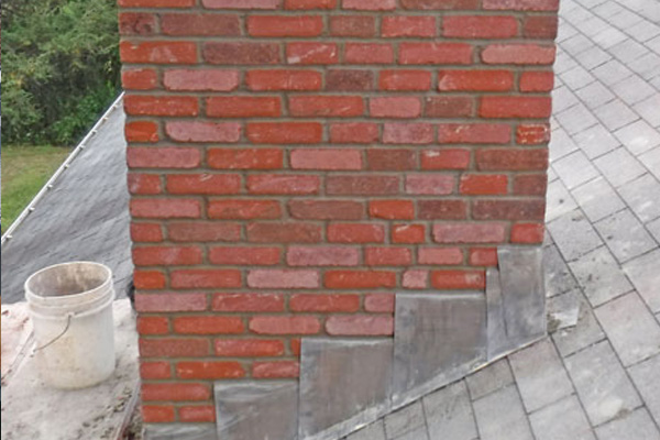 Roofer carrying out a detailed roof inspection